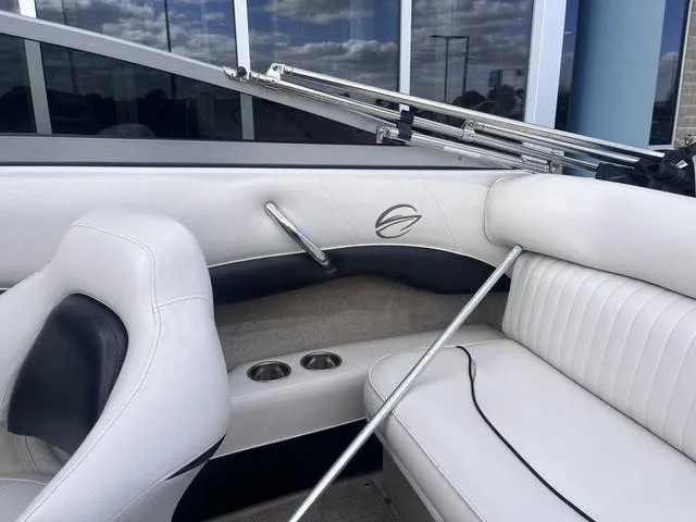 Slide: The Image of 2013 Crownline 18 SS boat interior with white seating and cup holders. - 27