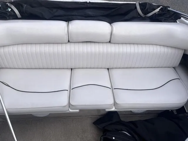 Slide: The Image of 2013 Crownline 18 SS boat interior with white cushioned seating. - 29