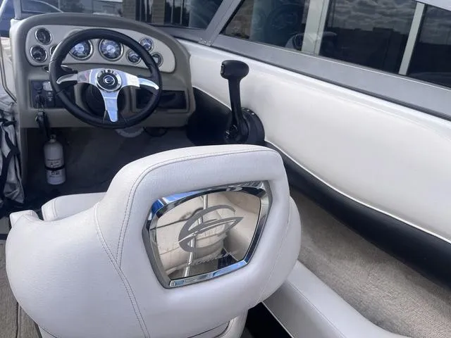 Slide: The Image of Interior of a 2013 Crownline 18 SS boat, featuring steering wheel and dashboard controls. - 30