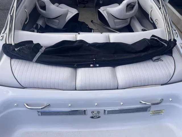 Slide: The Image of 2013 Crownline 18 SS boat interior with white seating and black cover. - 8