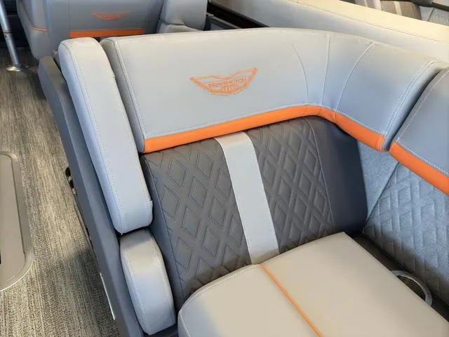 Slide: The Image of 2025 Bennington 22ML Cruise boat interior with gray and orange cushioned seating. - 11