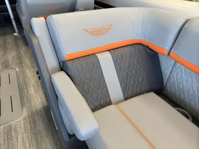 Slide: The Image of Luxurious seating on 2025 Bennington 22ML Cruise boat with gray and orange accents. - 12