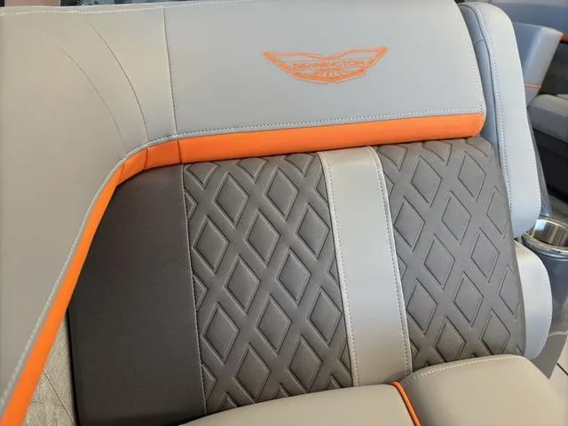 Slide: The Image of 2025 Bennington 22ML Cruise seat with diamond pattern and orange accents. - 13
