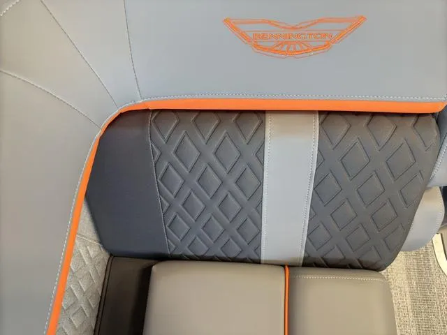 Slide: The Image of Luxurious seating in 2025 Bennington 22ML Cruise with diamond stitching and orange accents. - 18