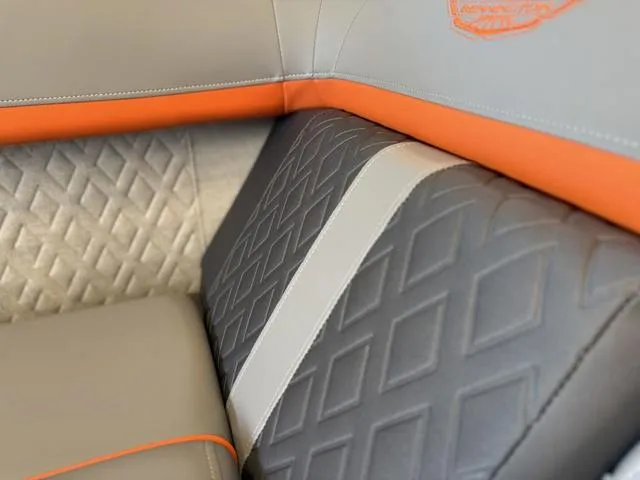 Slide: The Image of Luxurious seating detail of 2025 Bennington 22ML Cruise with diamond-patterned upholstery and orange accents. - 20