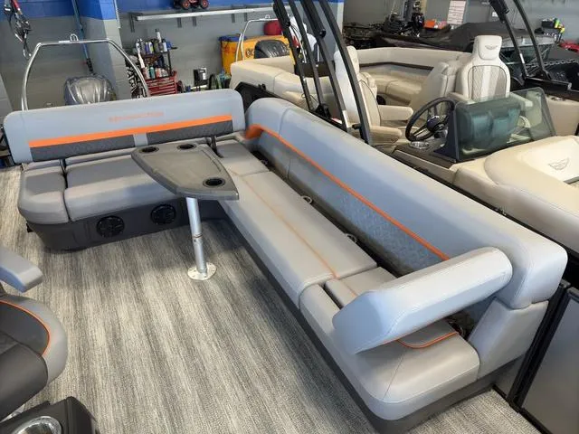 Slide: The Image of 2025 Bennington 22ML Cruise boat interior with gray seating and orange accents. - 26