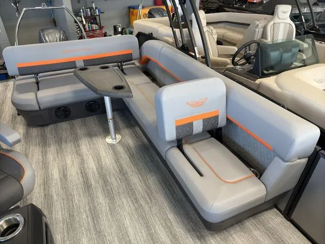 Slide: The Image of 2025 Bennington 22ML Cruise boat interior with gray seating and orange accents. - 27