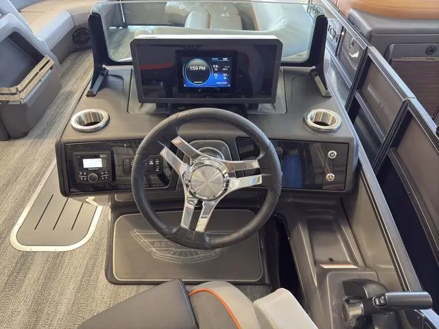 Slide: The Image of 2025 Bennington 22ML Cruise dashboard with steering wheel and digital display. - 31