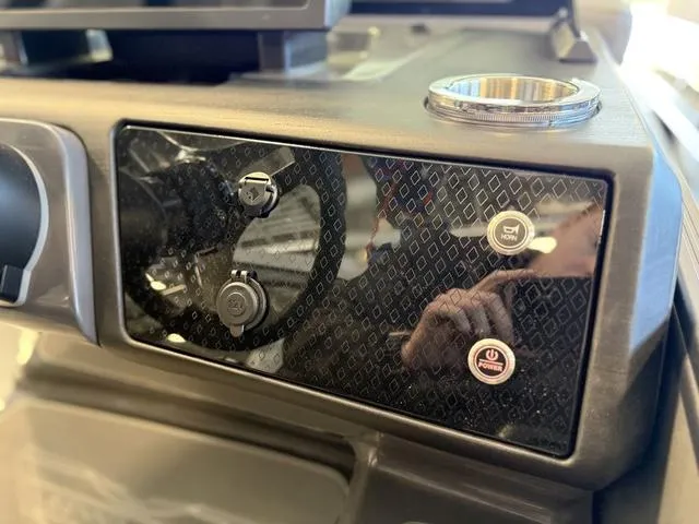 Slide: The Image of Dashboard of 2025 Bennington 22ML Cruise boat with control buttons and cup holder. - 35