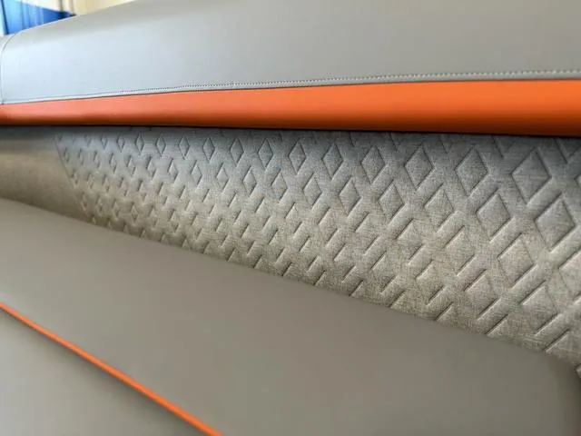 Slide: The Image of 2025 Bennington 22ML Cruise interior with gray and orange diamond-patterned upholstery. - 37