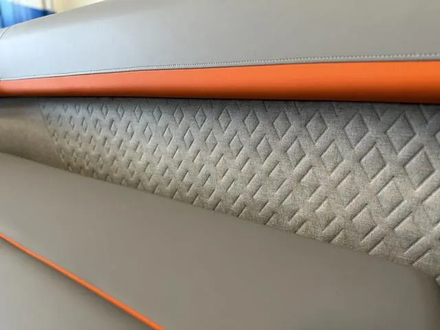 Slide: The Image of Luxurious seating detail of 2025 Bennington 22ML Cruise with textured upholstery and orange accents. - 38