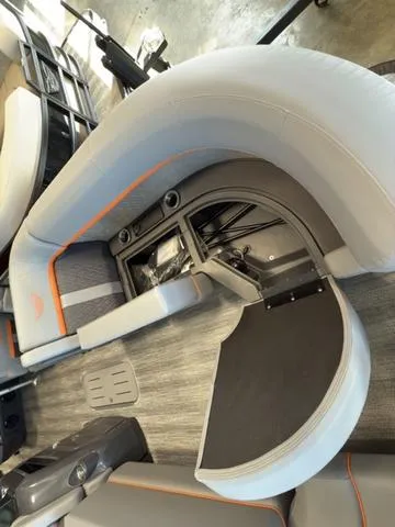 Slide: The Image of Interior view of 2025 Bennington 22ML Cruise boat with open storage compartment. - 6