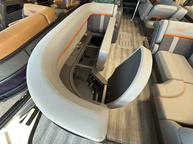 Slide: The Image of 2025 Bennington 22ML Cruise interior with gray seating and storage compartments. - 7
