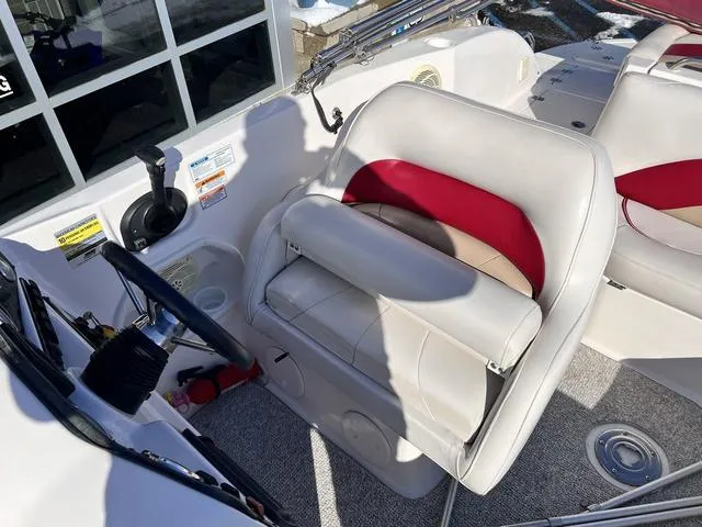 Slide: The Image of 2005 Hurricane FUNDECK202 boat interior with white and red seating, steering wheel, and controls. - 10