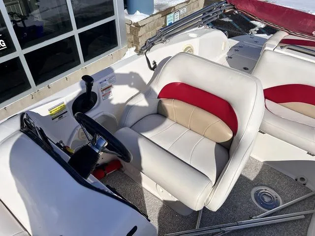 Slide: The Image of 2005 Hurricane FUNDECK202 boat interior with white and red seating, steering wheel, and controls. - 11