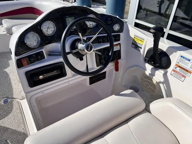 Slide: The Image of 2005 Hurricane FUNDECK202 boat dashboard with steering wheel and control panel. - 9