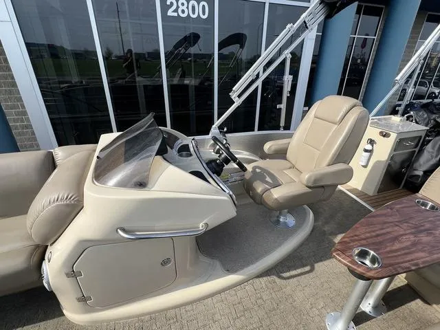 Slide: The Image of 2015 Godfrey 2500 FE BAR boat interior with captain's chair and control panel. - 13