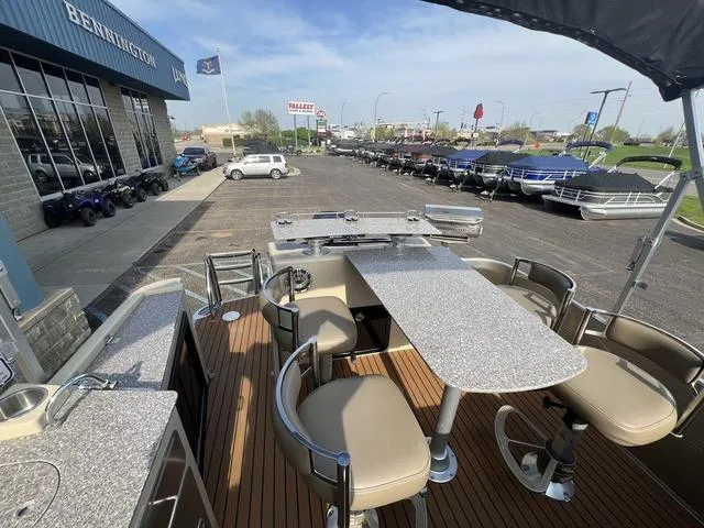 Slide: The Image of Pontoon boat with bar seating, docked at dealership, Godfrey 2500 FE BAR, 2015 model. - 18
