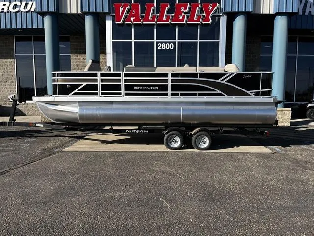 Slide: The Image of 2025 Bennington 22SF Tri-Toon Pontoon on trailer outside dealership. - 1