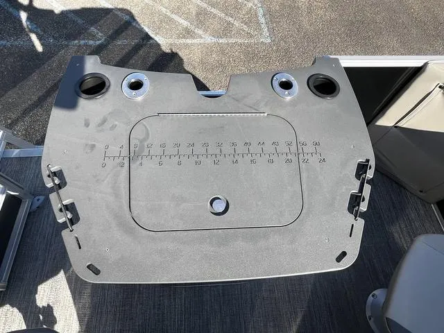 Slide: The Image of 2025 Bennington 22SF Tri-Toon Pontoon fishing station with built-in measuring board and cup holders. - 10