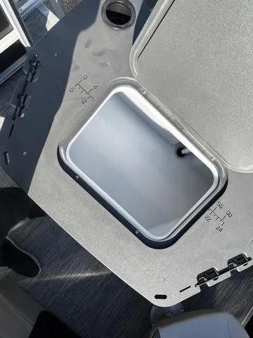 Slide: The Image of Open storage compartment on 2025 Bennington 22SF Tri-Toon Pontoon boat. - 11