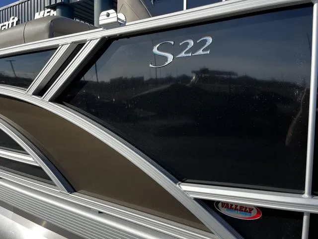 Slide: The Image of 2025 Bennington 22SF Tri-Toon Pontoon, sleek design with "S22" emblem, close-up view. - 2