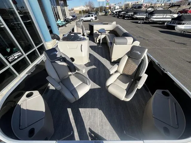 Slide: The Image of 2025 Bennington 22SF Tri-Toon Pontoon with luxurious seating and modern design at a dealership. - 4