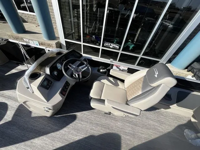 Slide: The Image of 2025 Bennington 22SF Tri-Toon Pontoon helm with captain's chair and control panel. - 7