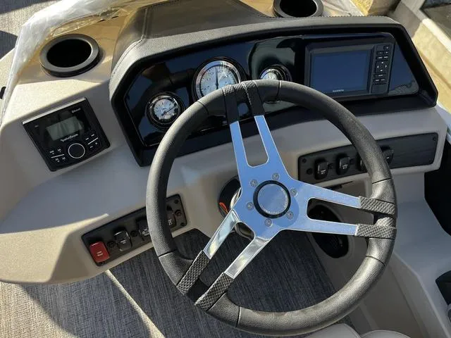 Slide: The Image of Steering console of 2025 Bennington 22SF Tri-Toon Pontoon with modern controls and gauges. - 8