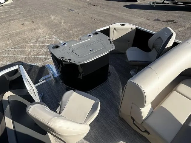 Slide: The Image of 2025 Bennington 22SF Tri-Toon Pontoon interior with seating and table, showcasing luxury design. - 9