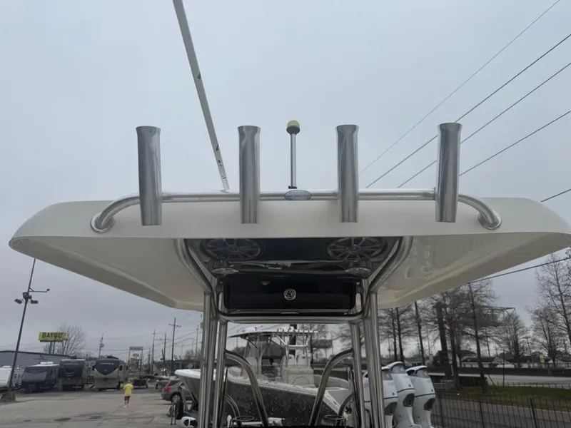 Slide: The Image of 2012 ShearWater 25LTZ boat with rod holders and T-top, parked outdoors. - 11