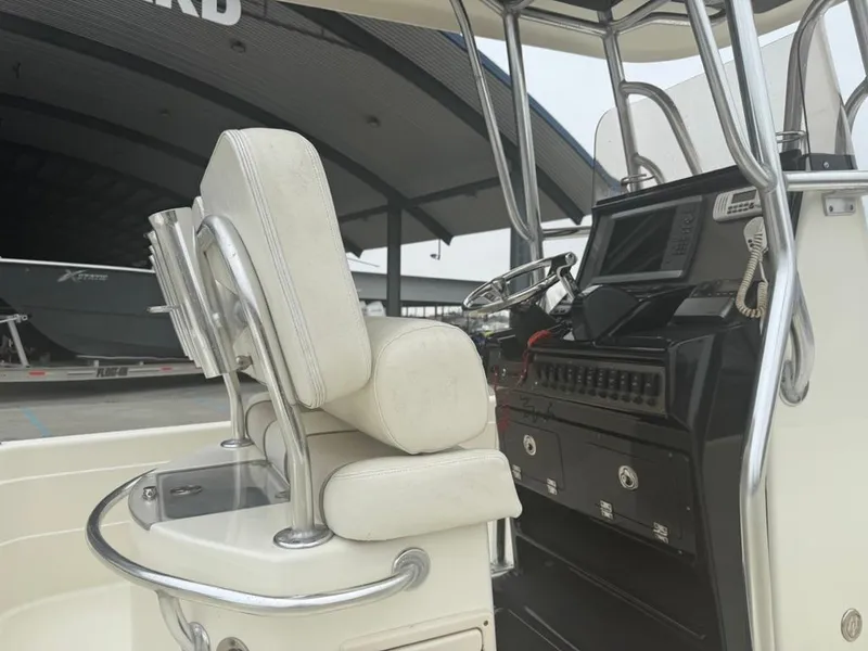 Slide: The Image of 2012 ShearWater 25LTZ boat interior with helm, seating, and control panel. - 12