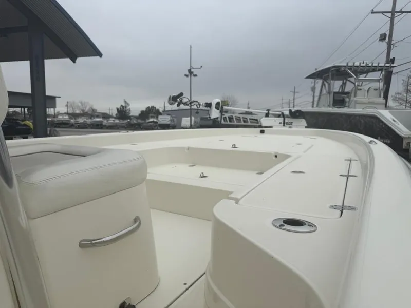 Slide: The Image of 2012 ShearWater 25LTZ boat deck with seating, overcast sky in marina setting. - 14