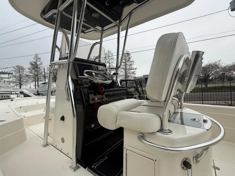 Slide: The Image of 2012 ShearWater 25LTZ boat interior with helm and seating, showcasing sleek design and controls. - 17