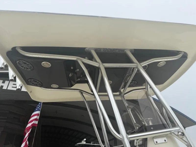 Slide: The Image of 2012 ShearWater 25LTZ boat with T-top and speakers, American flag in background. - 19