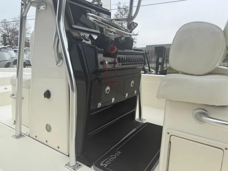 Slide: The Image of 2012 ShearWater 25LTZ boat console with seating and storage compartments. - 20