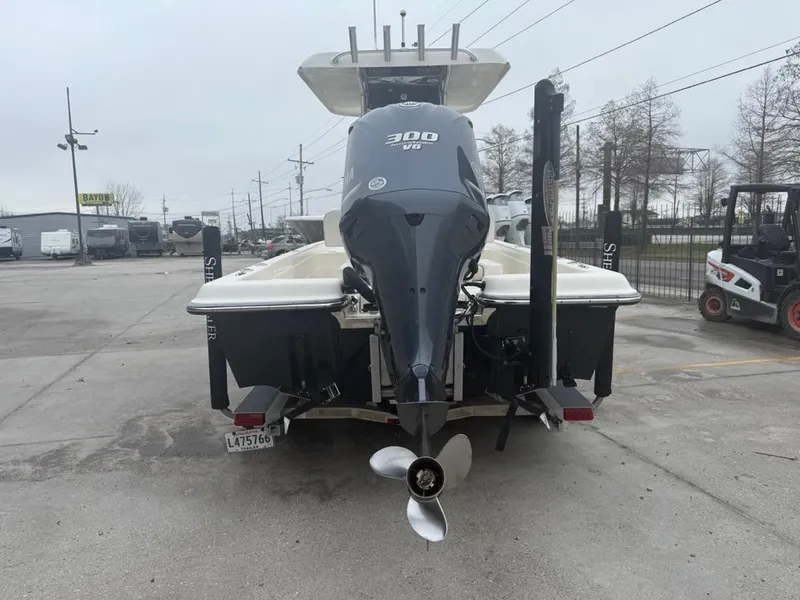 Slide: The Image of 2012 ShearWater 25LTZ boat with 300 HP engine, rear view in a parking lot. - 4
