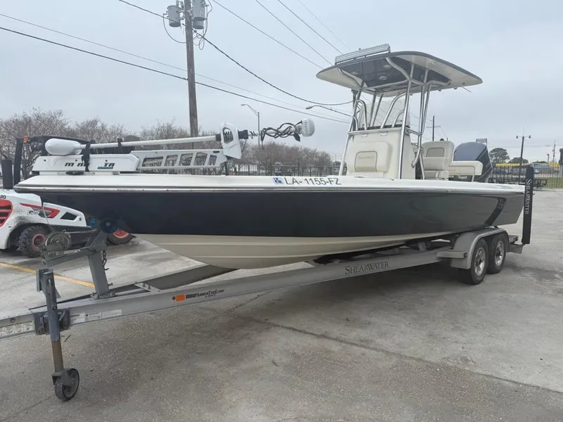 Slide: The Image of 2012 ShearWater 25LTZ boat on trailer, parked outdoors. - 6