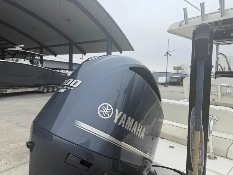 Slide: The Image of 2012 ShearWater 25LTZ boat with Yamaha outboard motor in a marina setting. - 8