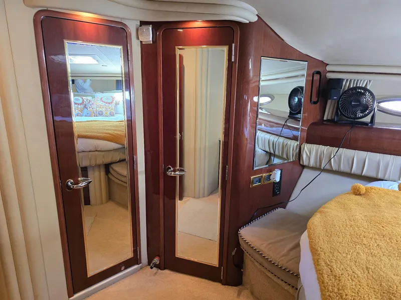 Slide: The Image of Luxurious interior of 2002 Sea Ray 560 Sedan Bridge with mirrored doors and elegant furnishings. - 17