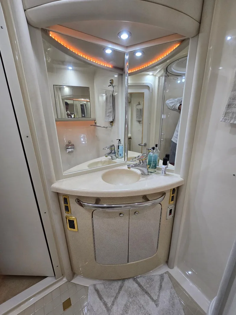 Slide: The Image of Luxurious bathroom in 2002 Sea Ray 560 Sedan Bridge yacht with modern fixtures and ambient lighting. - 22