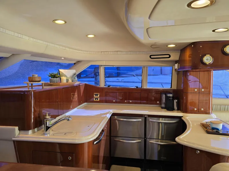 Slide: The Image of Luxurious kitchen interior of 2002 Sea Ray 560 Sedan Bridge yacht with modern amenities. - 23