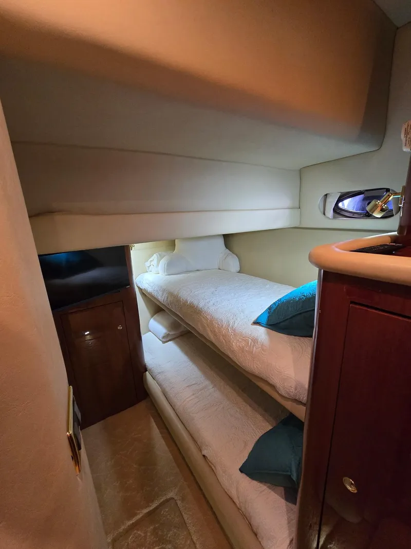 Slide: The Image of Interior of 2002 Sea Ray 560 Sedan Bridge with cozy bunk beds. - 26