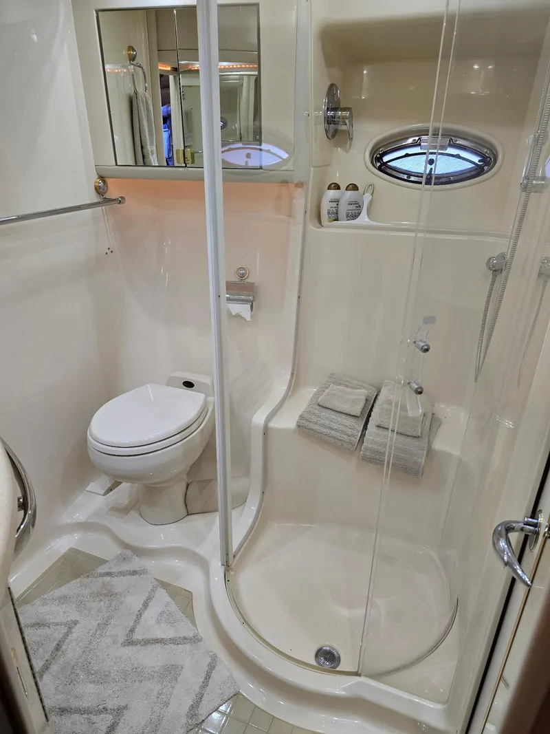 Slide: The Image of Luxurious bathroom in 2002 Sea Ray 560 Sedan Bridge yacht with shower and toilet. - 29