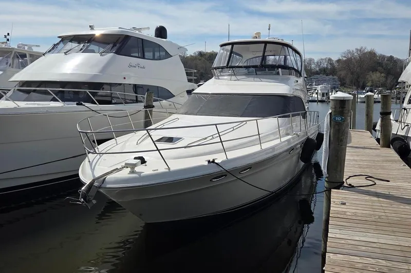 Slide: The Image of 2002 Sea Ray 560 Sedan Bridge yacht docked at marina, side view. - 5