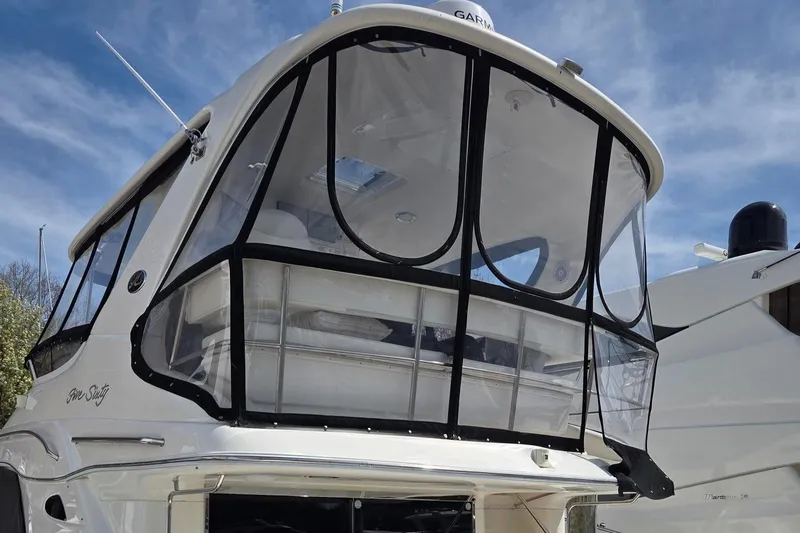 Slide: The Image of 2002 Sea Ray 560 Sedan Bridge yacht with enclosed flybridge under a clear blue sky. - 6