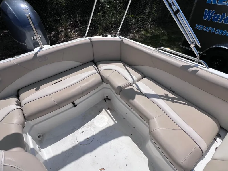 Slide: The Image of 2017 NauticStar 203SC Sport Deck boat interior with beige seating and spacious layout. - 10
