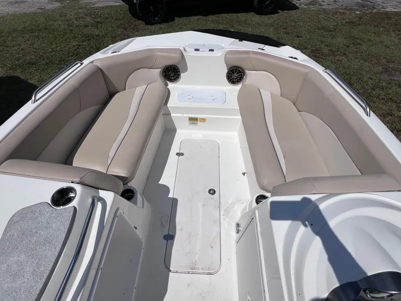 Slide: The Image of 2017 NauticStar 203SC Sport Deck boat interior with beige seating and cup holders. - 18