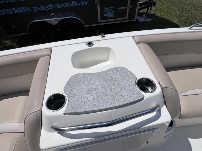 Slide: The Image of 2017 NauticStar 203SC Sport Deck boat interior with cup holders and seating area. - 19