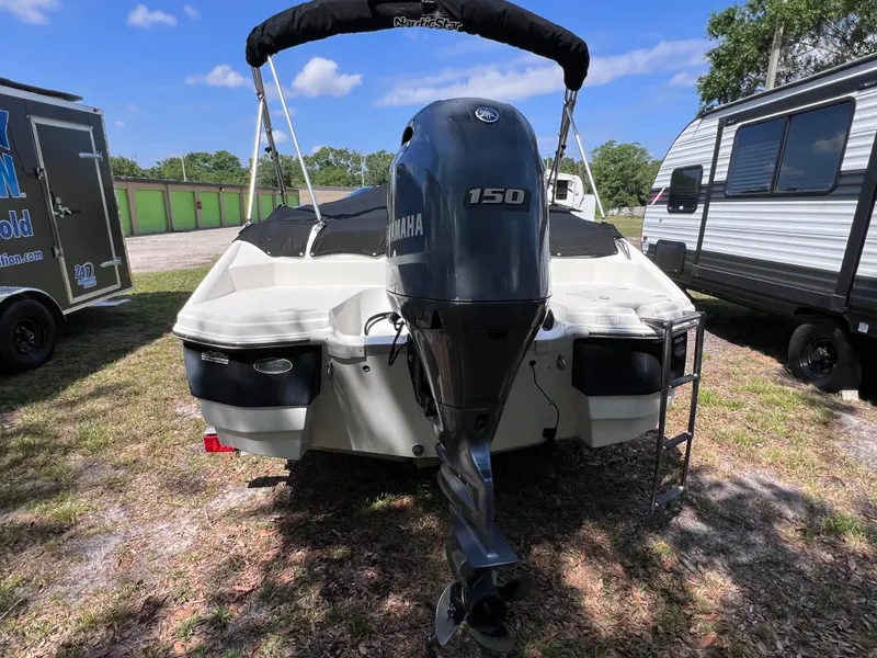 Slide: The Image of 2017 NauticStar 203SC Sport Deck boat with Yamaha 150 engine, parked outdoors. - 2